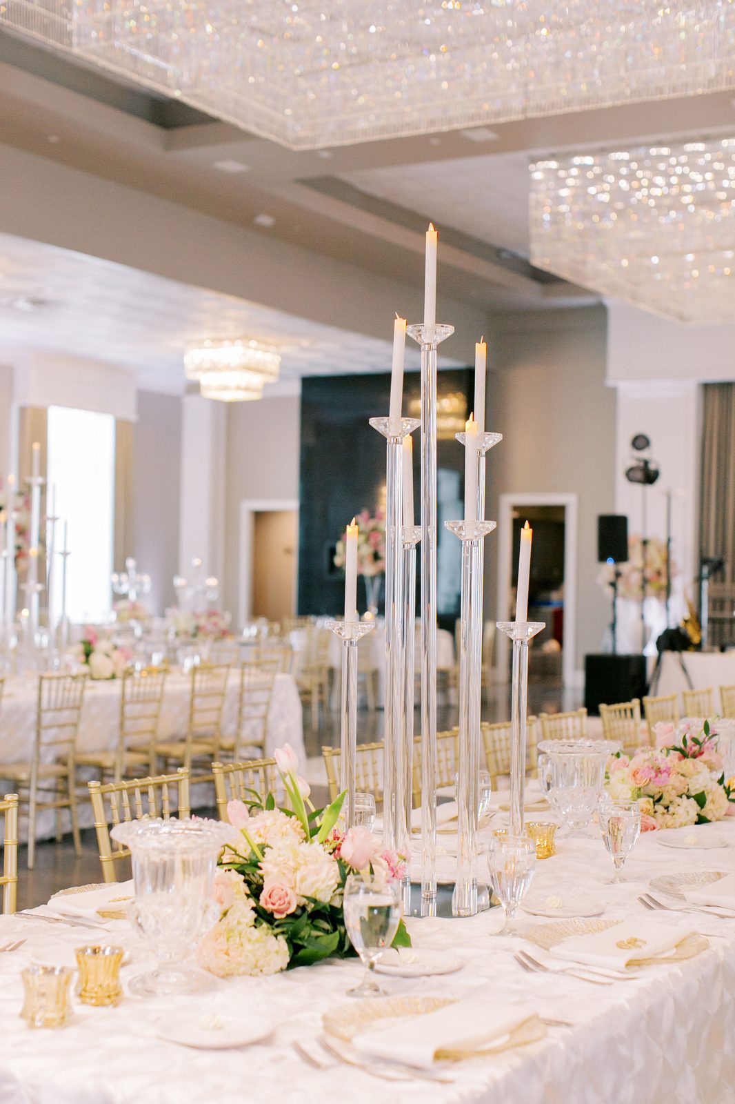 Tall crystal candelabra with a floral centerpiece at an evening event
