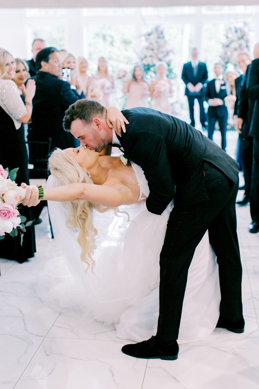 Alexa and Brian's recessional dip kiss after the ceremony
