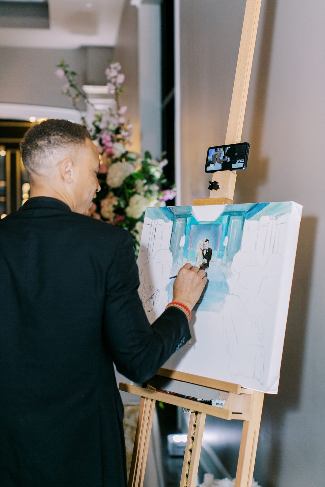 A live painter capturing the ceremony on canvas