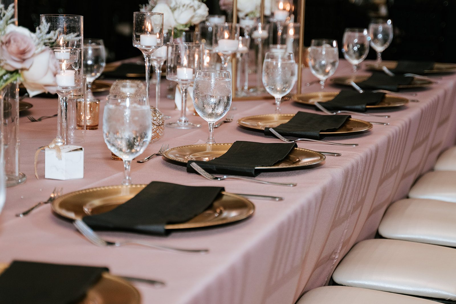 Reception table set with blush linens and gold chargers