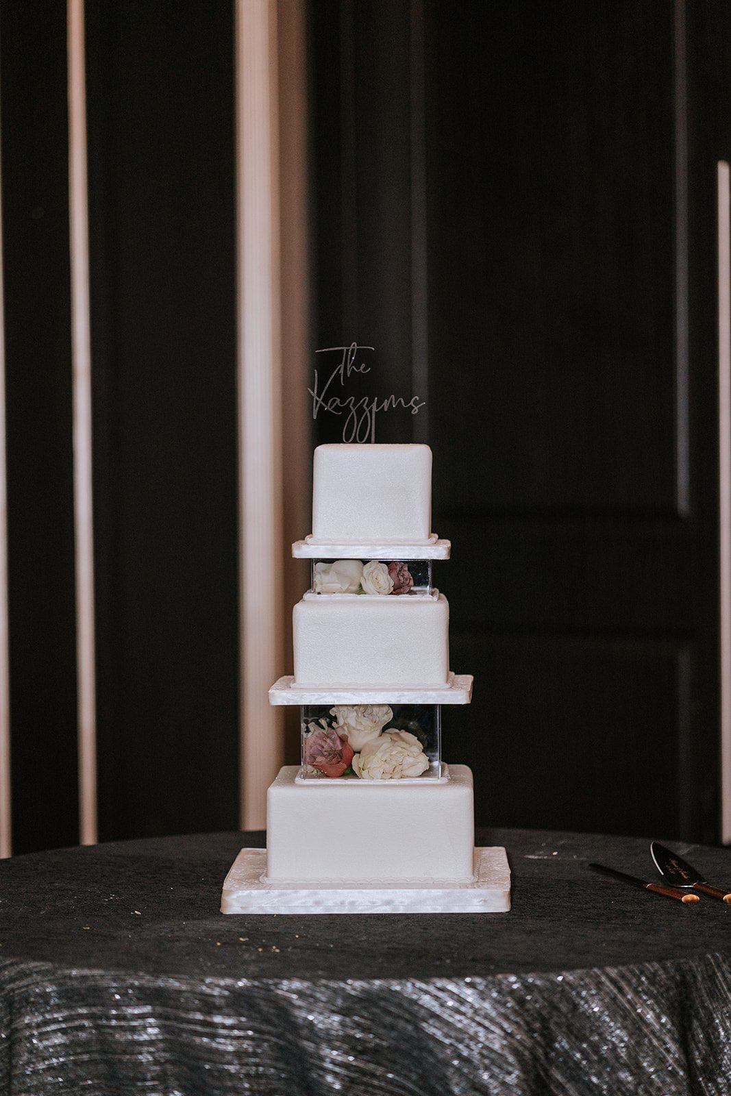 Four-tier square wedding cake with floral accents