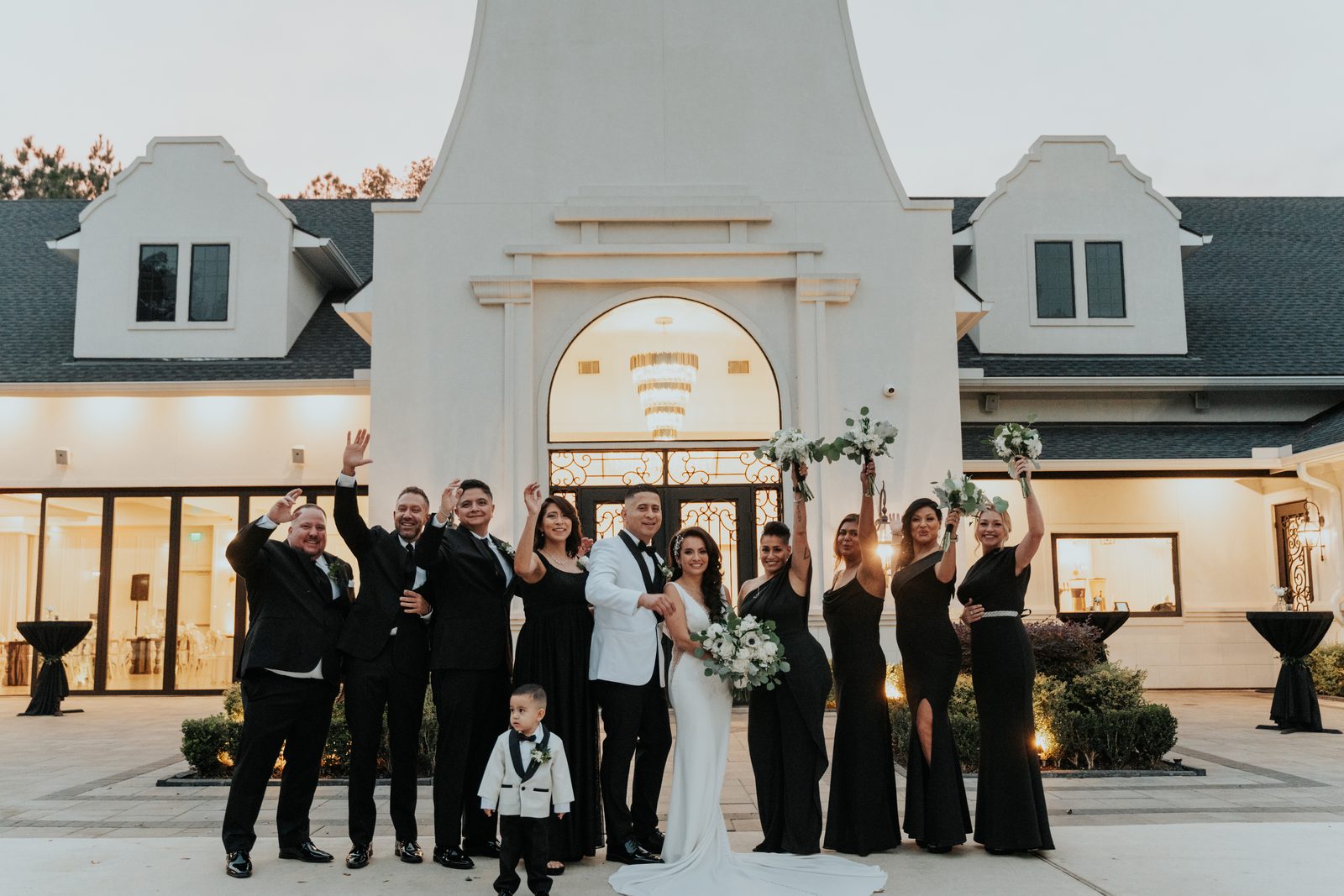 Full wedding party celebrating at dusk