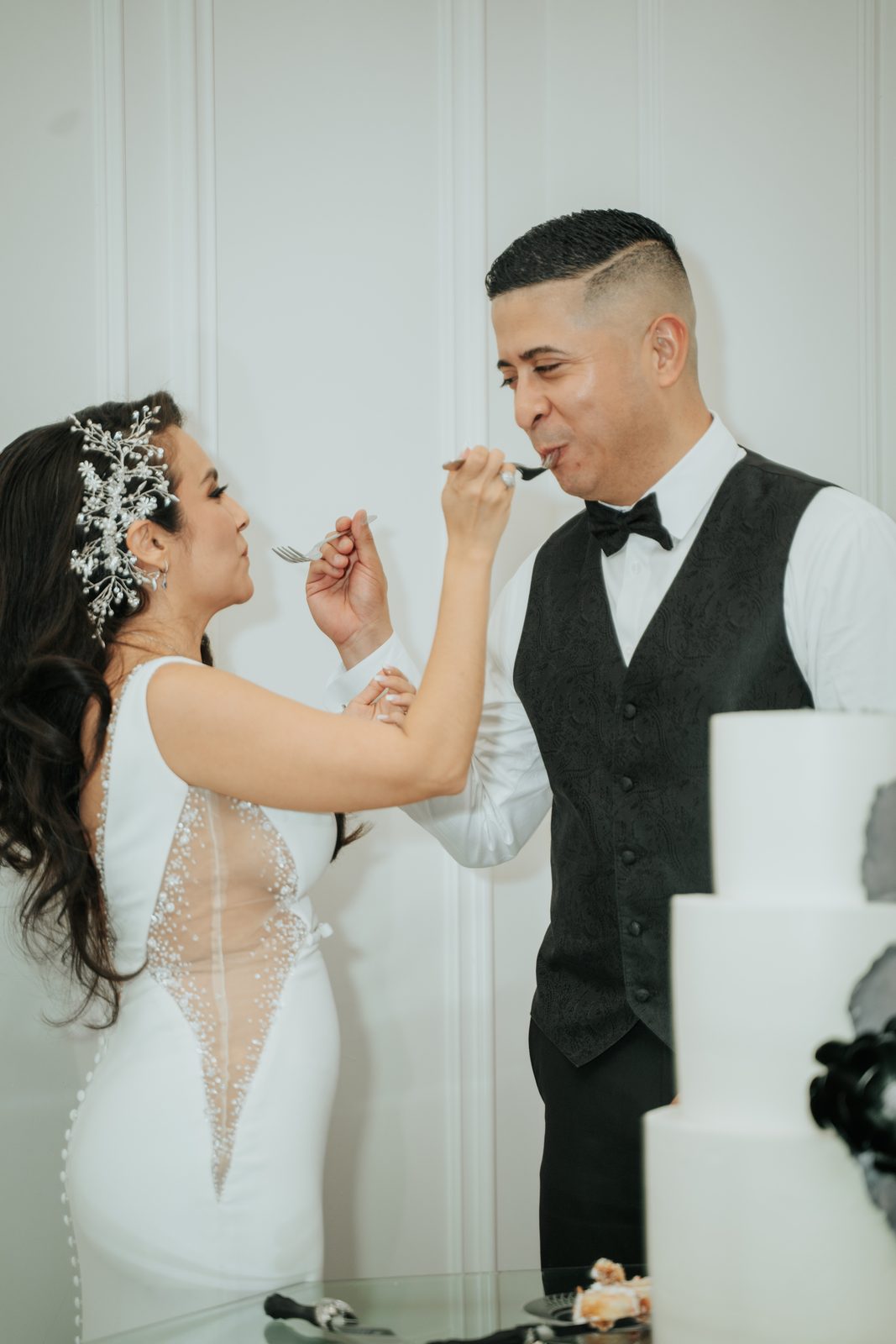 Amber and Walter feeding each other cake