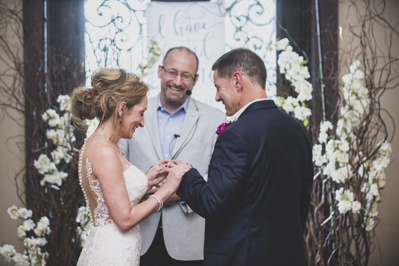 Carrie and Tony exchanging rings at the altar