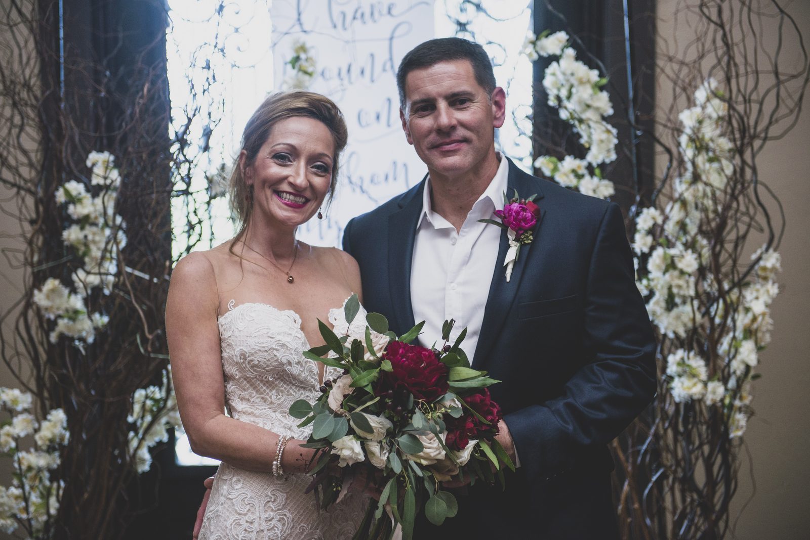 Carrie and Tony portrait at the ceremony arch