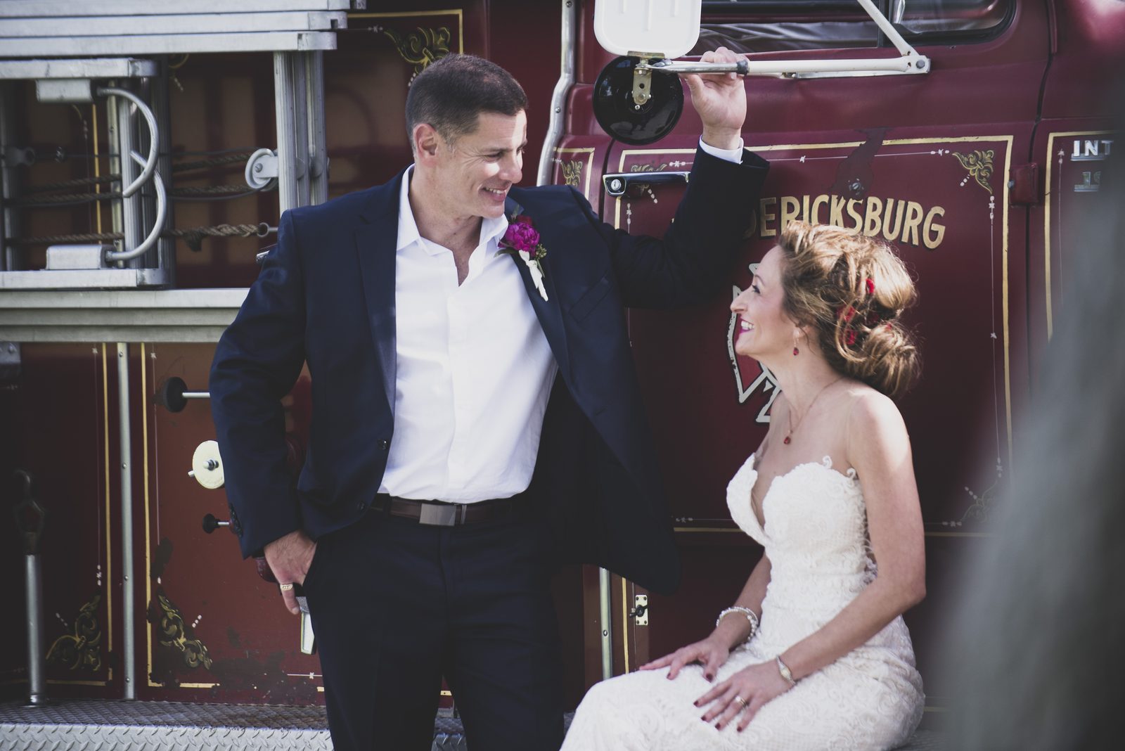 Carrie and Tony laughing together by the fire truck