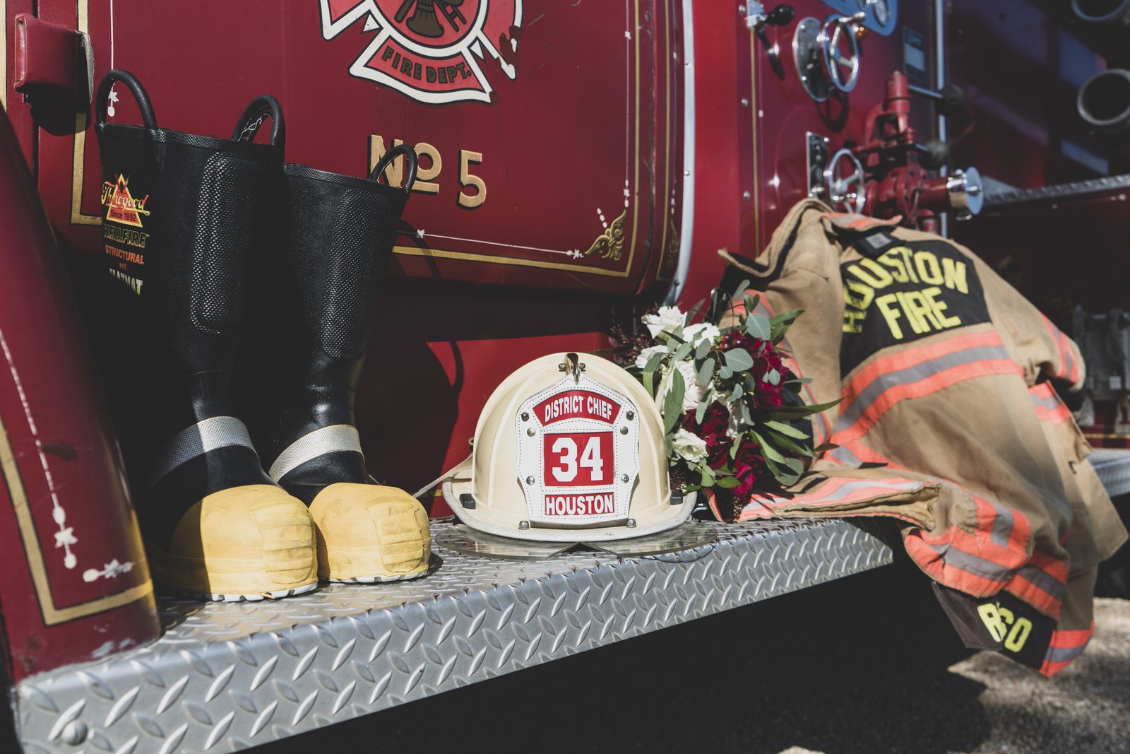 Firefighter gear and bouquet detail on the truck's running board