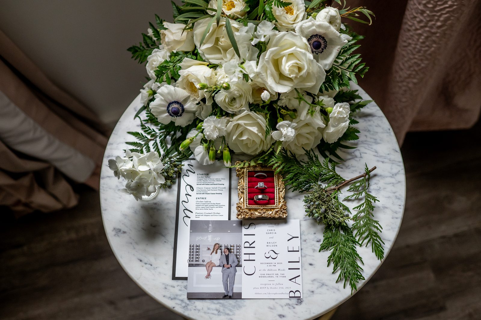 Bouquet, rings, and invitation suite detail shot