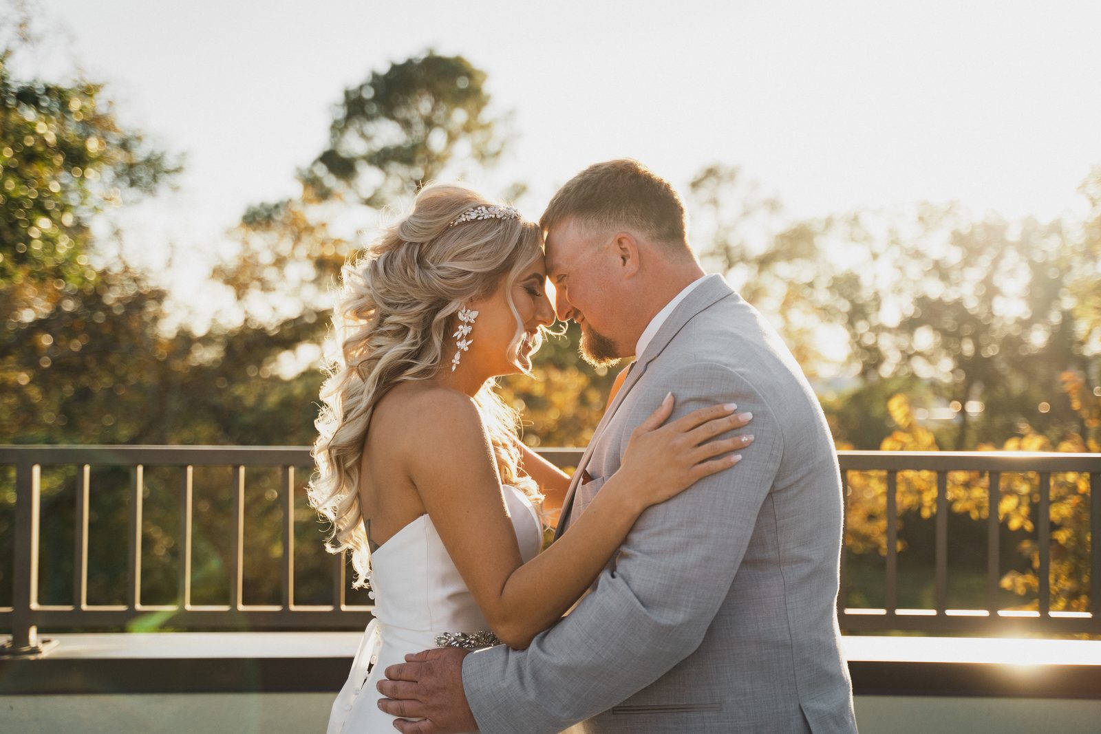 Erica and Tyler embracing forehead to forehead at golden hour