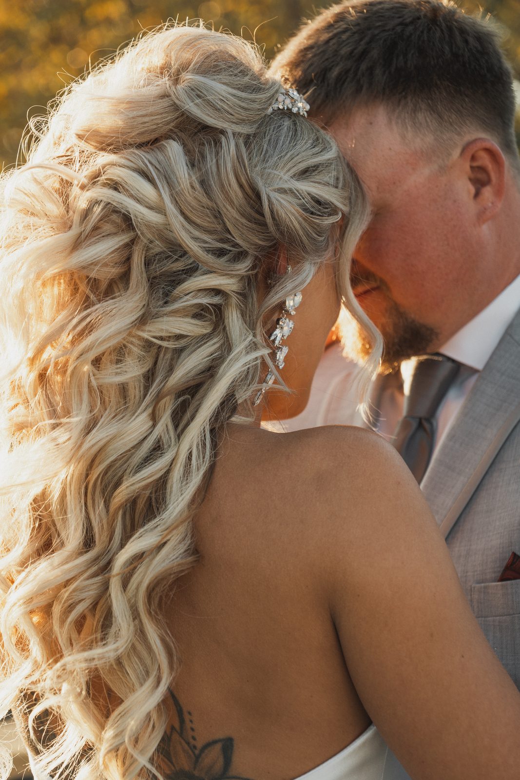 Close-up of Erica's hair and earrings during their embrace