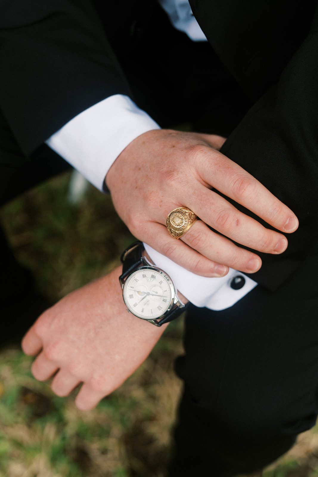 Detail of Tanner's watch and class ring