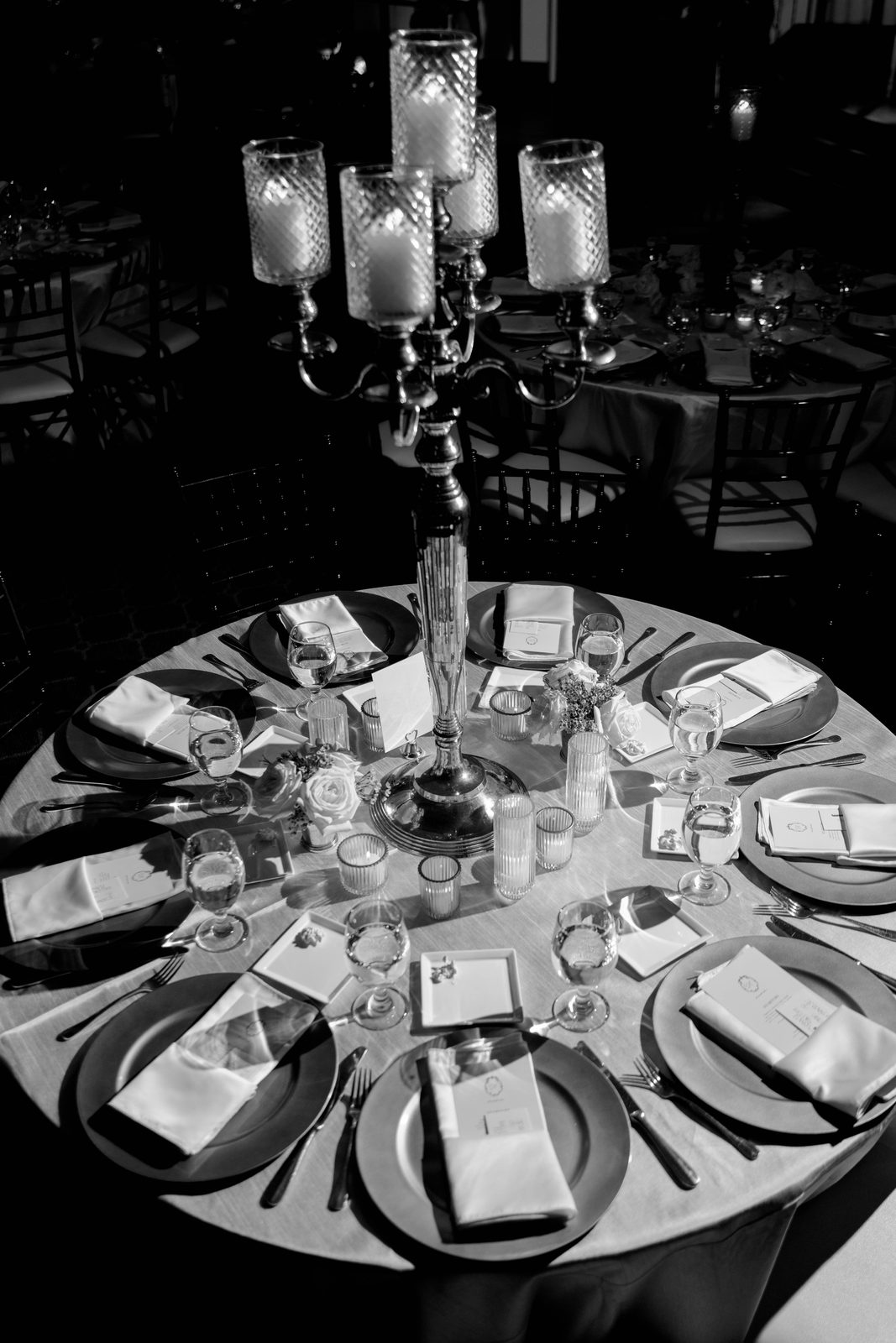 Black and white overhead view of a reception table with a candelabra