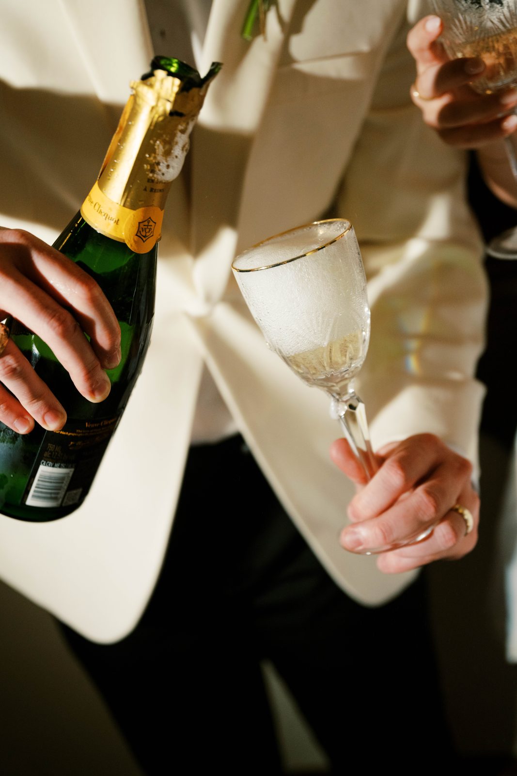 Champagne being poured into a frosted glass