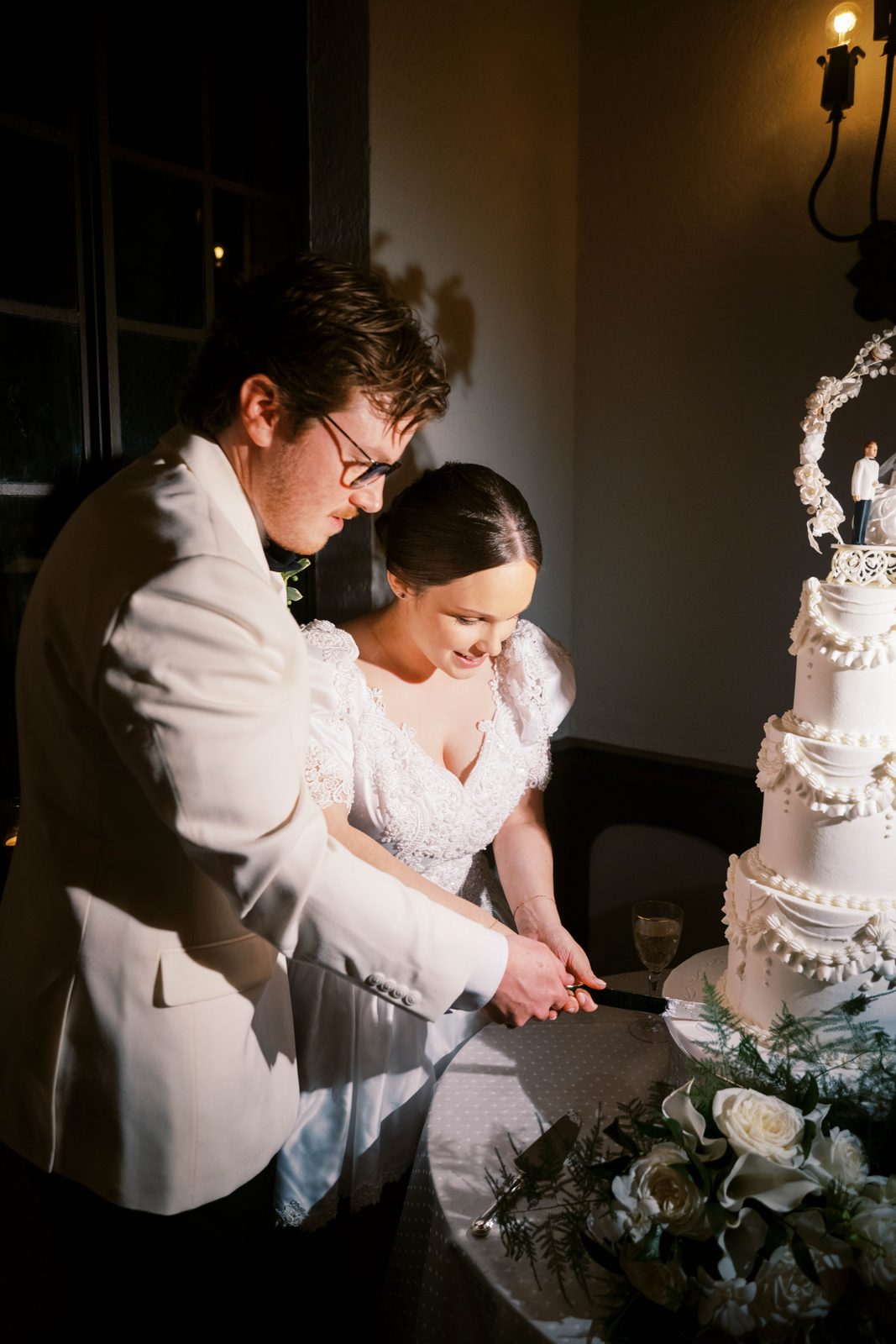 Madison and Tanner cutting their wedding cake