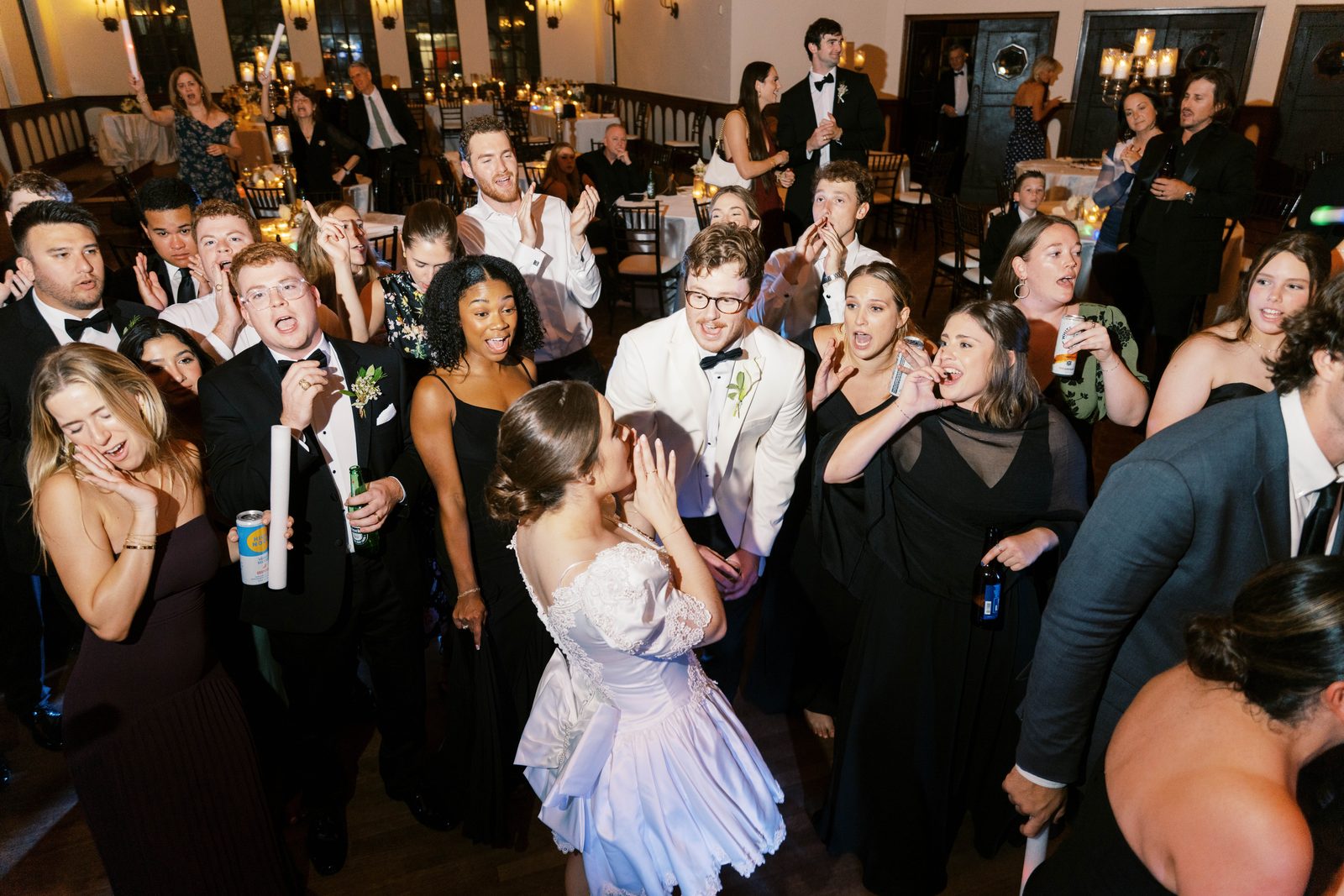 Guests singing along on a packed dance floor