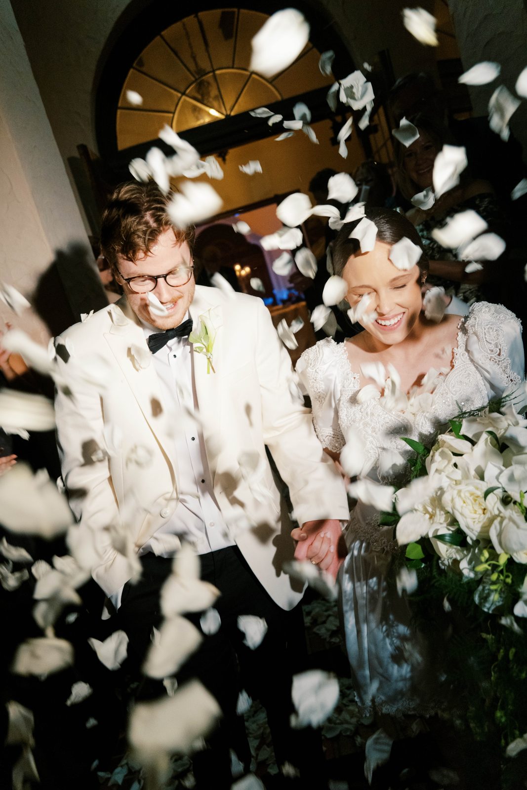 Madison and Tanner walking through a shower of flower petals