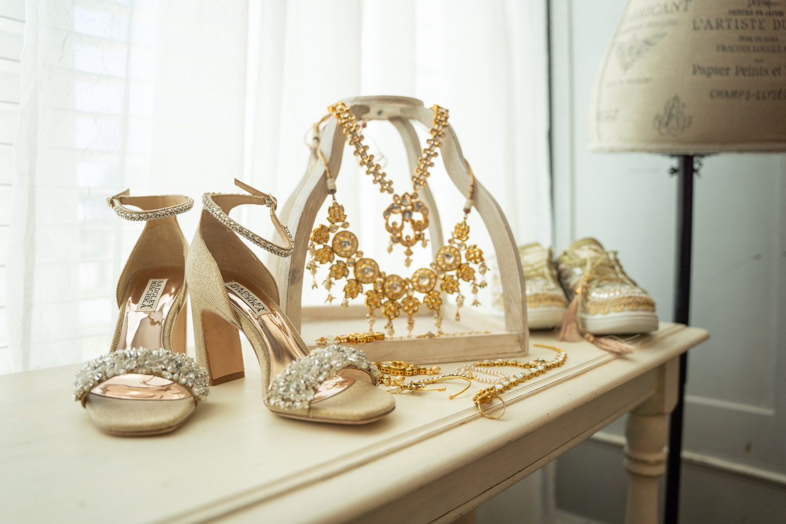 Bridal shoes and traditional gold jewelry detail