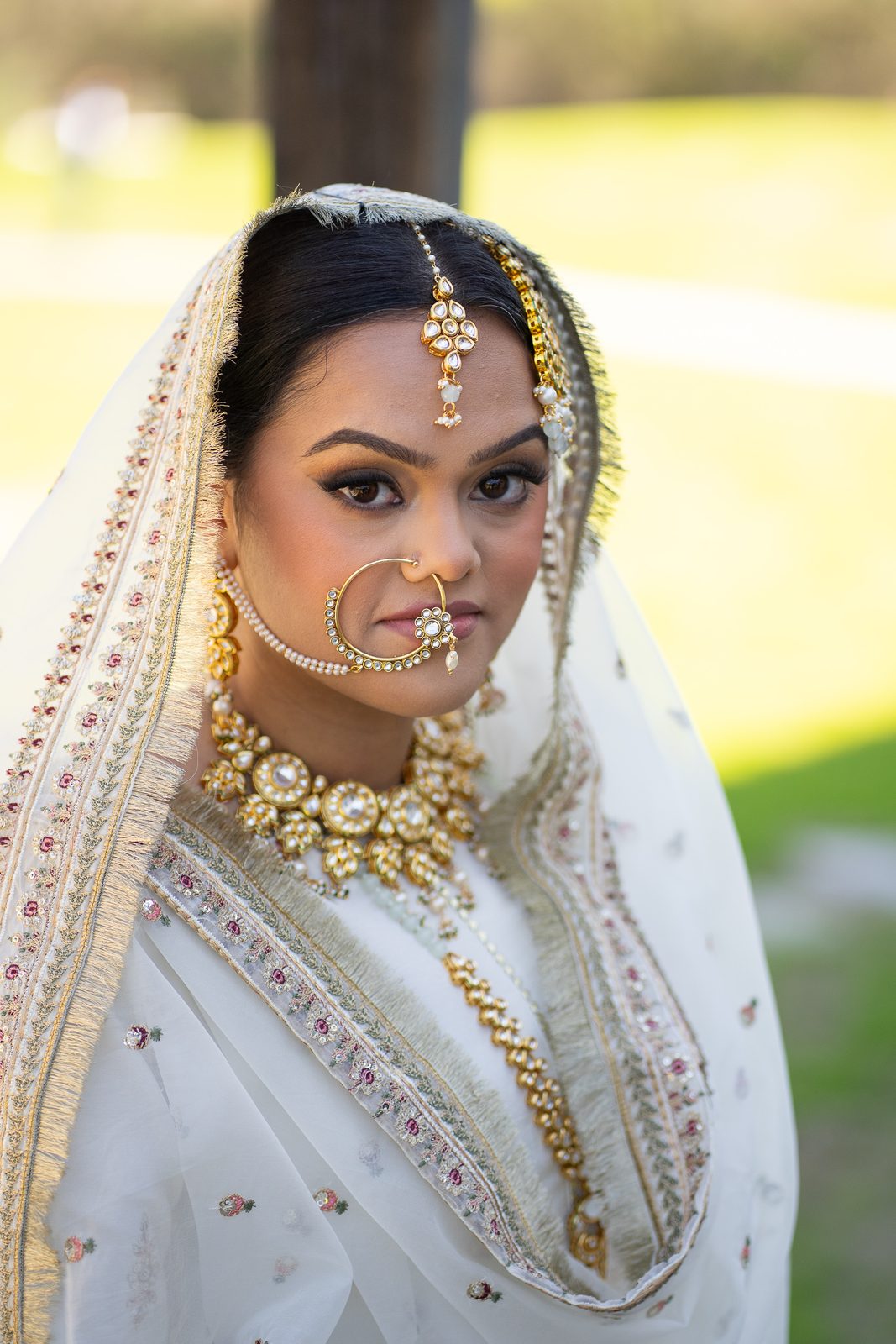 Maria bridal portrait in traditional white and gold dress