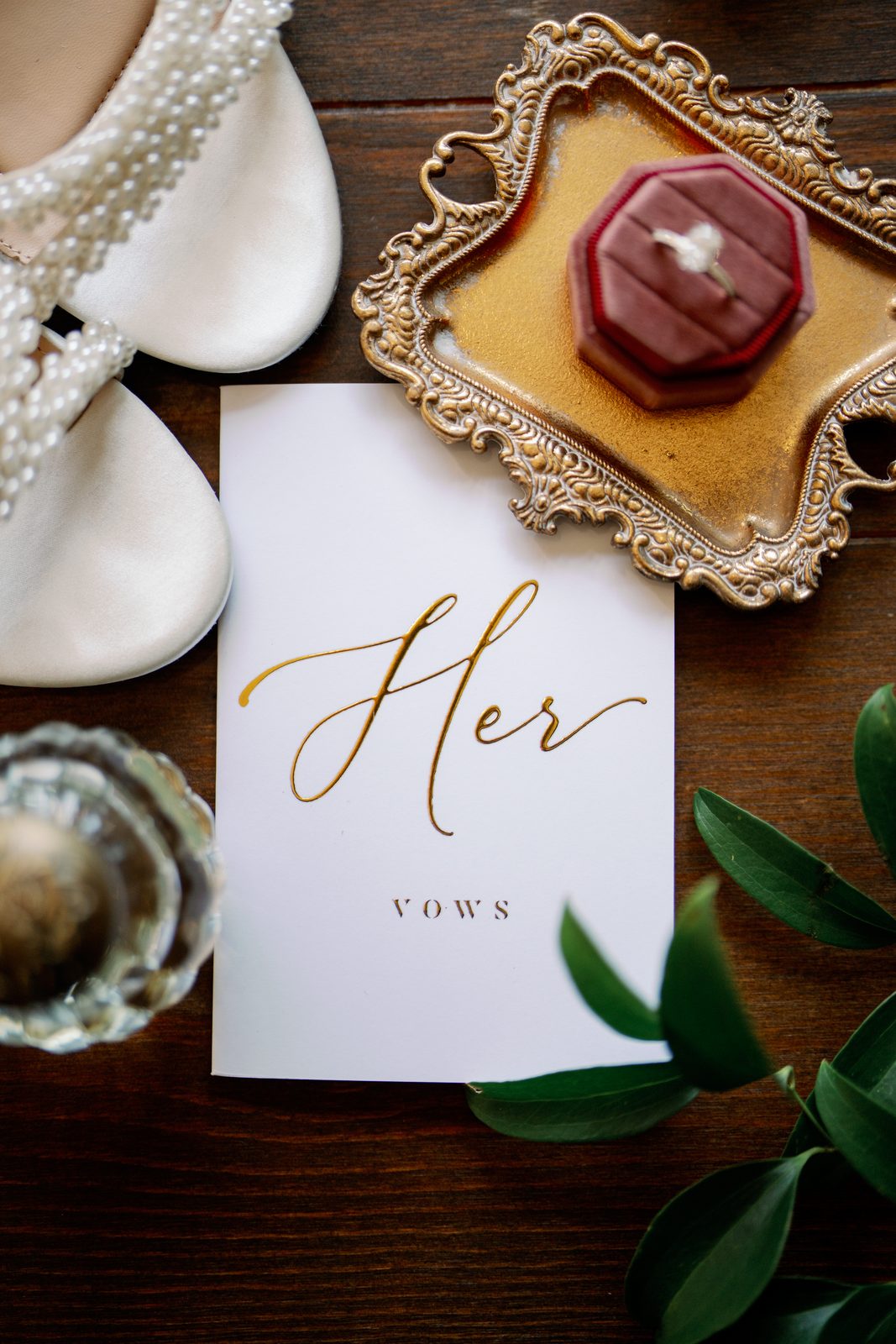 Bridal shoes, vows card, and ring box flatlay