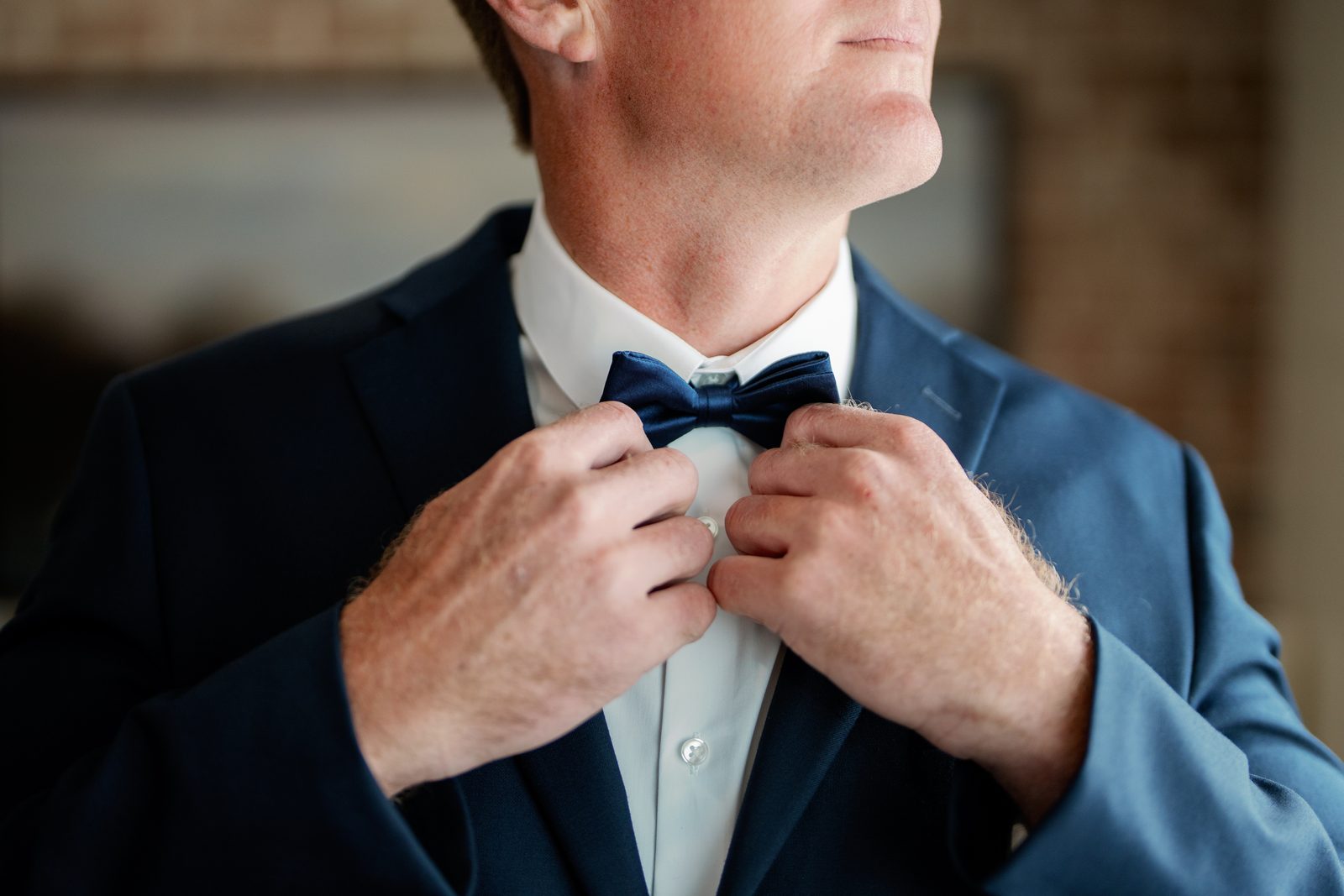 Close-up of David adjusting his bow tie