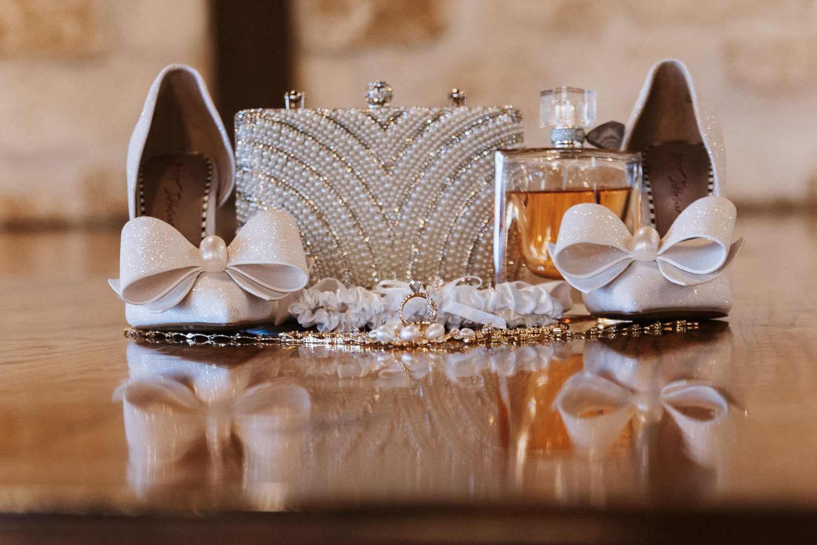 Perla's bridal details: shoes, clutch, garter, and ring