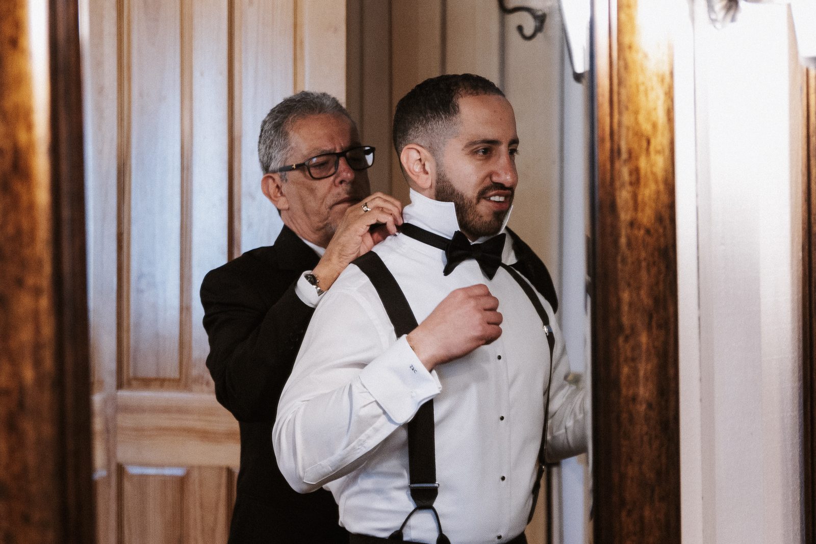 Steven's father adjusting his suspenders