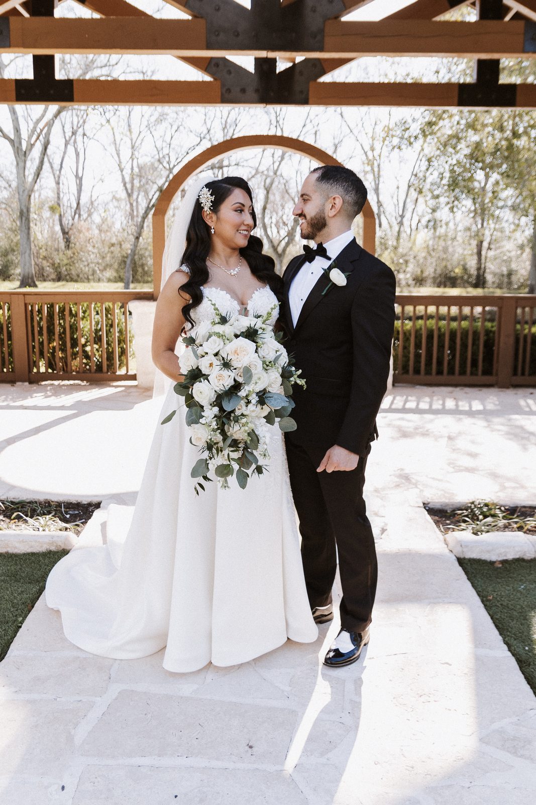 Perla and Steven portrait under a wooden pergola