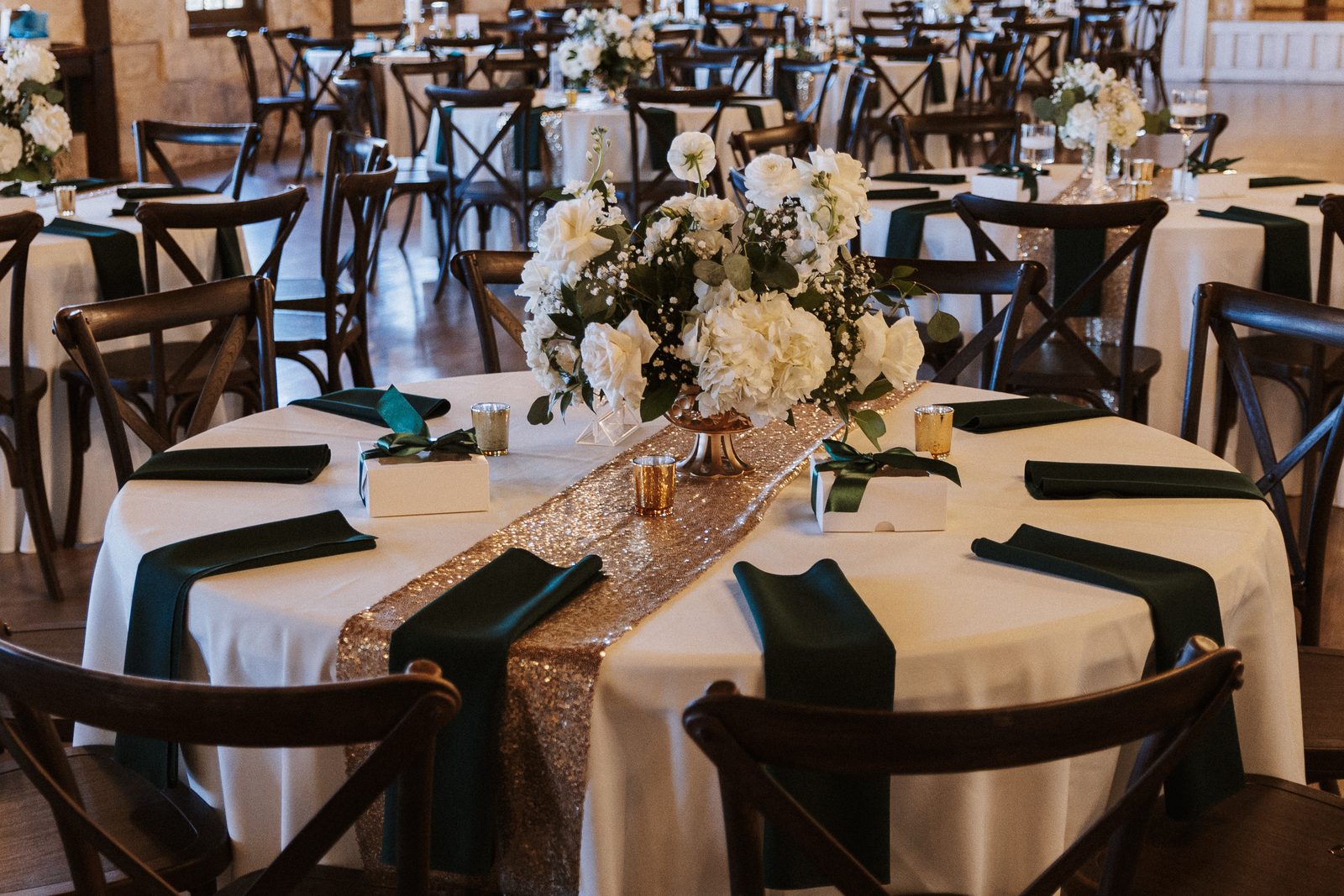 Table setting with florals, favor boxes, and a sequin runner