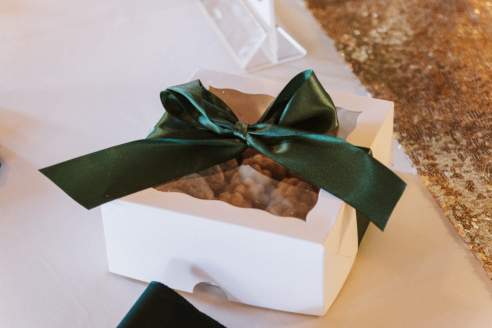 Cookie favor box tied with a green ribbon