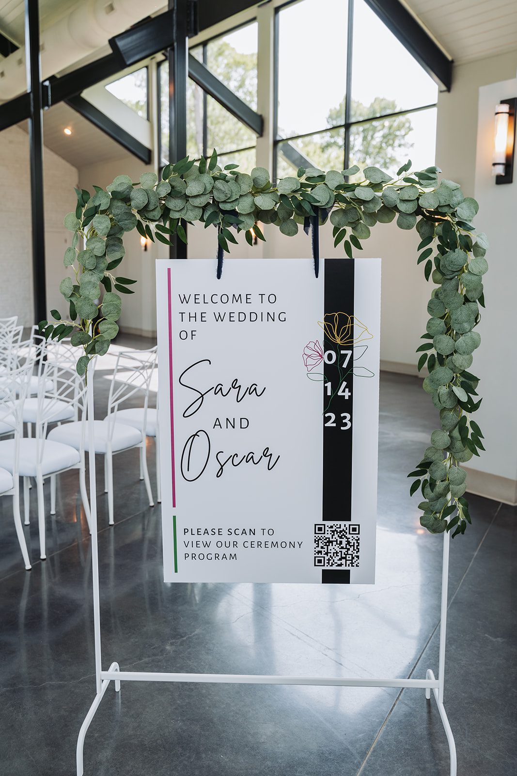 Welcome sign for Sara and Oscar's ceremony, framed in eucalyptus