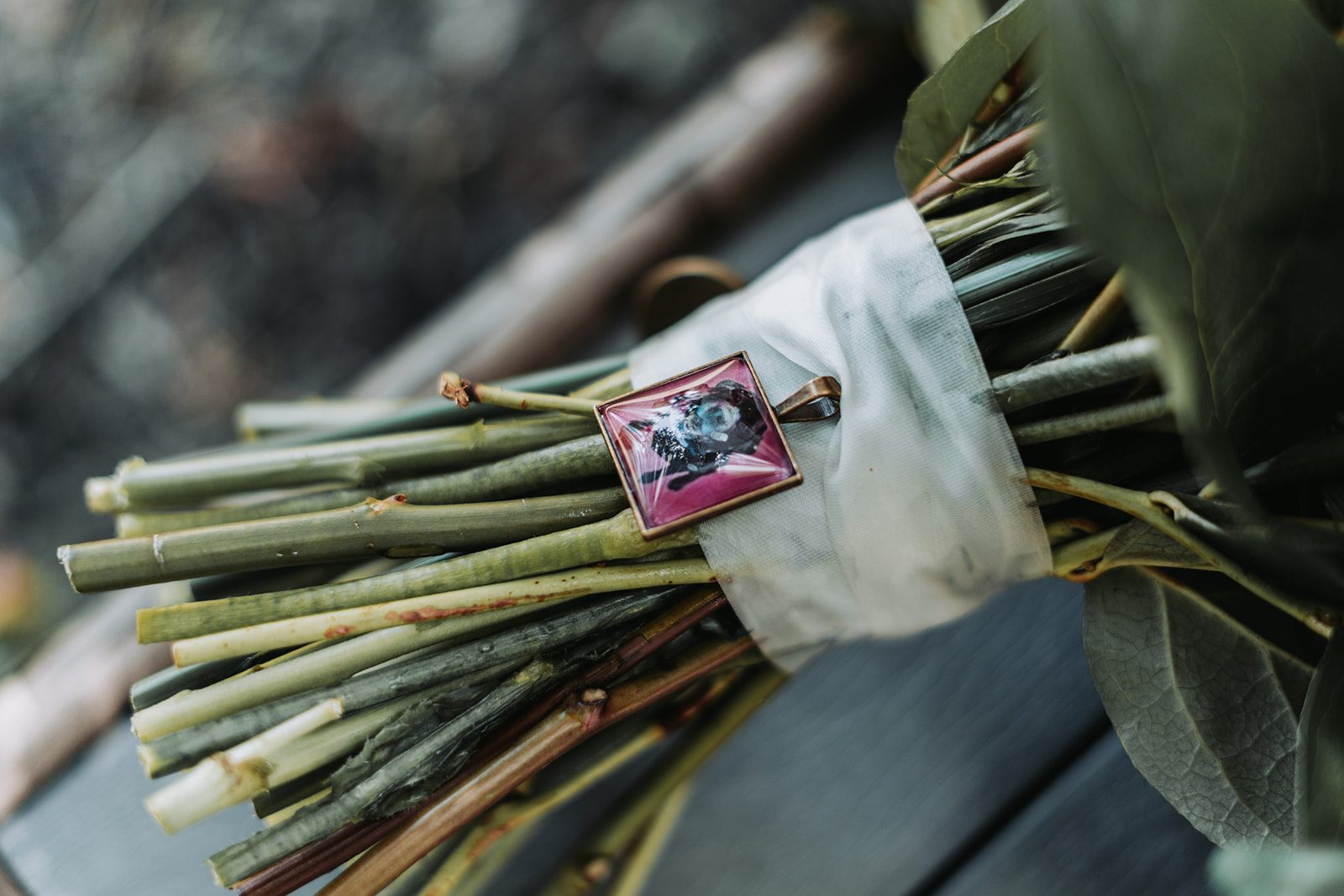 Bouquet detail with a memorial photo charm
