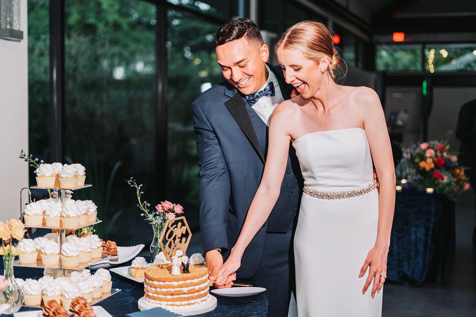 Sara and Gus cutting their wedding cake